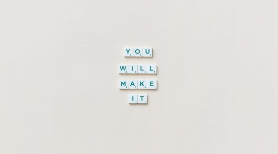 Motivational phrase 'You Will Make It' made from Scrabble tiles on a neutral background.